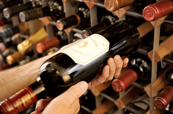 a grabbing a bottle of wine from the wine cellar